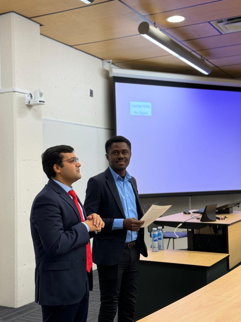 George Amoako presenting with a colleague at a UNBC Investment Club event
